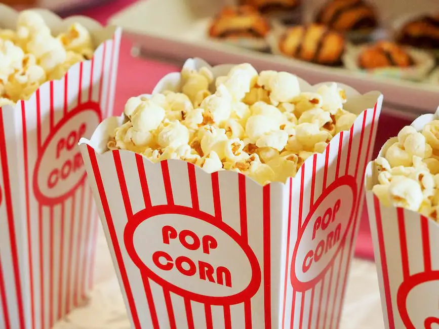 Illustration of a person smelling popcorn in a movie theater with a thought bubble of a shopping cart representing impulse buying