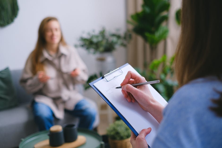 An image showing a person holding a satisfaction survey clipboard with a happy face on it, representing customer satisfaction measurement.