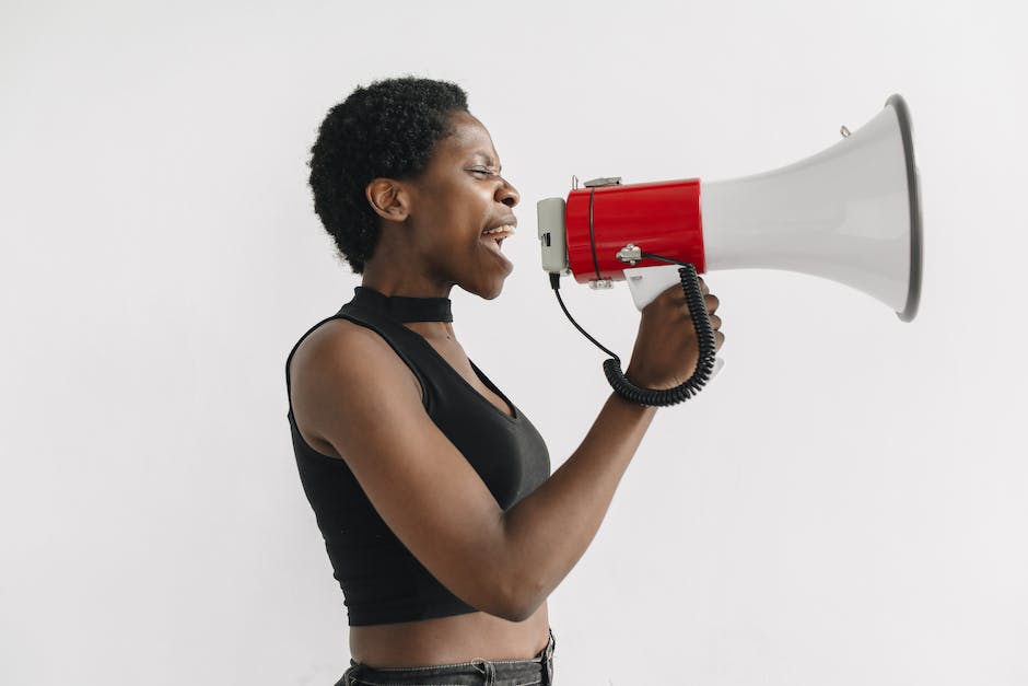 Illustration of a person holding a megaphone with the words 'Owned Media' written on it, representing the power and control businesses have over their own media channels.