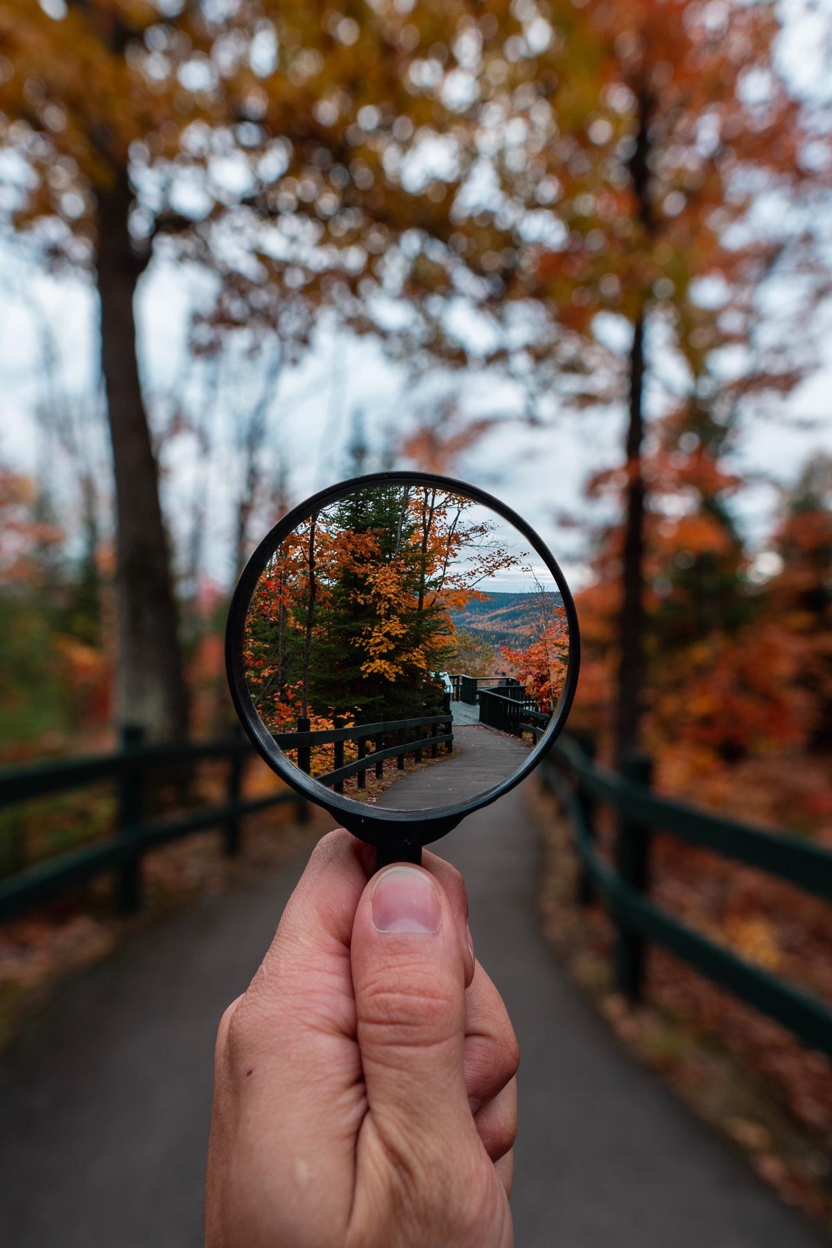 An image of a person holding a magnifying glass, symbolizing the concept of 'positioning' in marketing.