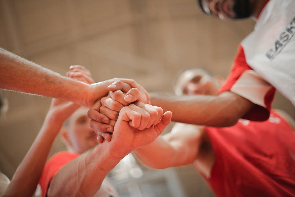 A group of diverse people shaking hands, representing the concept of sponsorship opportunities.